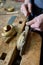 Craftsman carving a piece of wood to make a golden frame