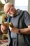 Craftsman carving a piece of wood to make a golden frame