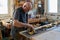 Craftsman carving a piece of wood to make a golden frame