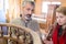 Craftsman with customer examining antique wooden furniture