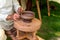 Craftsman hand making pottery from clay on potters wheel