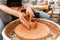 Craftsman hands making pottery bowl. Woman working on potter wheel . Family business shop sculpts pot from clay view top