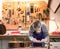 Craftsman in his workshop leveling the frets of a guitar