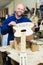 Craftsman holding unfinished guitar