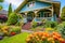 craftsman house with overhanging eaves, with a colorful garden