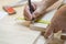 Craftsman measuring wood with ruler