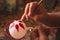 Craftsman painting Christmas spheres in his workshop in different colors