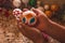 Craftsman painting Christmas spheres in his workshop in different colors