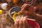 Craftsman painting Christmas spheres in his workshop in different colors