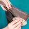 Craftsman polishes an edge the handbag with wax