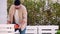 Craftsman polishes a wooden pallet furniture with orbital sander machine, furniture restoration. Seasonal house chores, woodworkin