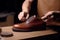 Craftsman professional care leather shoes closeup. Generate Ai