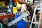 Craftsman in protective mask with plumbing pipe at hardware store