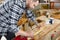 Craftsman sanding a guitar neck in wood at workshop