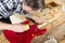 Craftsman sanding a guitar neck in wood at workshop