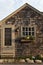 Craftsman style cottage with wood shingles, window and flowerbox