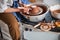 Craftsman using pottery loop tool while trimming clay dish