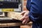 Craftsman woodworking at carpentry with lots of modern professional power tools. Man using thicknessing machine and circular saw