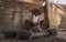 Craftsman working in his workshop, carving the stone to make molcajetes