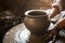 Craftsmanship. Close-up of hands working clay on potter\'s wheel.