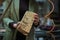 A craftsperson examines a uniquely textured piece of burl wood, appreciating its complex patterns and potential for a