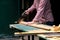 Craftswoman cutting plank with handsaw in workshop. Carpentry, construction, woodworking concept