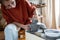 Craftswoman enjoying meditative process of making ceramics, shaping clay on pottery wheel