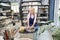 Craftswoman. Relaxed mature woman in blue apron looking focused while creating handmade clay ceramics in pottery