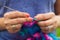Craftswoman`s hands knitting shawl with crochet