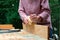 Craftswoman works with a wood planer outdoors. DIY, woodwork concept