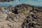 Craggy jagged shoreline with ocean in background