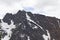 Craggy Mountain Peaks with an Arch or Snow Patch