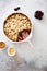 Cramble with berries, apples and almond on gray stone background