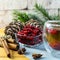 Cranberries in a glass plate. Frozen lingonberries in a glass plate on a wooden table.