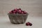 Cranberries in Metal Bowl with Loose Berries at Eye Level