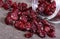 Cranberries spilling out of glass jar on concrete