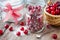 Cranberries with sugar, basket with berries and sugar bowl
