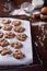 Cranberry cookies on a baking tray, cooking ingredients over rustic kitchen table. Crispy appetizers.
