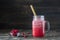 Cranberry and cowberry smoothie in mason jar with bamboo straw. Refreshing summer fruit drink. The concept of healthy eating. Copy