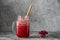 Cranberry and cowberry smoothie in mason jar with bamboo straw. Refreshing summer fruit drink. The concept of healthy eating. Copy