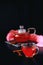 Cranberry herbal hot tea drink in glass teapot with cinnamon and