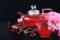 Cranberry herbal hot tea drink in glass teapot with cinnamon and