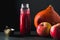 Cranberry sauce in a bottle, pumpkin and apples on a table side view