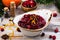 Cranberry sauce with ingredients on wooden table