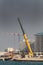 A crane carrying a sinking wooden boat in Doha, Qatar