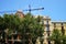 Crane and facades of houses in the area of Eixample in Barcelona.