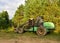 Crane forwarder machines at during clearing of a plantation. Wheeled harvester transports raw timber from the felling site out to