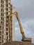 Crane in front of a stripped down apartment building