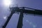 Crane for industrial handling of goods in the port with blue sky in the back