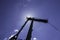 Crane for industrial handling of goods in the port with blue sky in the back